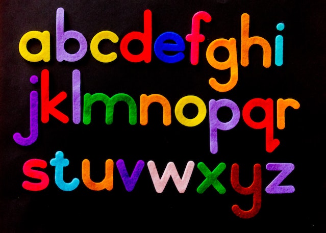 Multicoloured alphabet letters arranged on a black background
